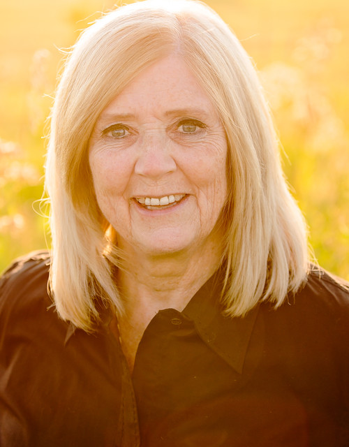 Holly Lundberg outdoors in low golden light, wearing a dark shirt.